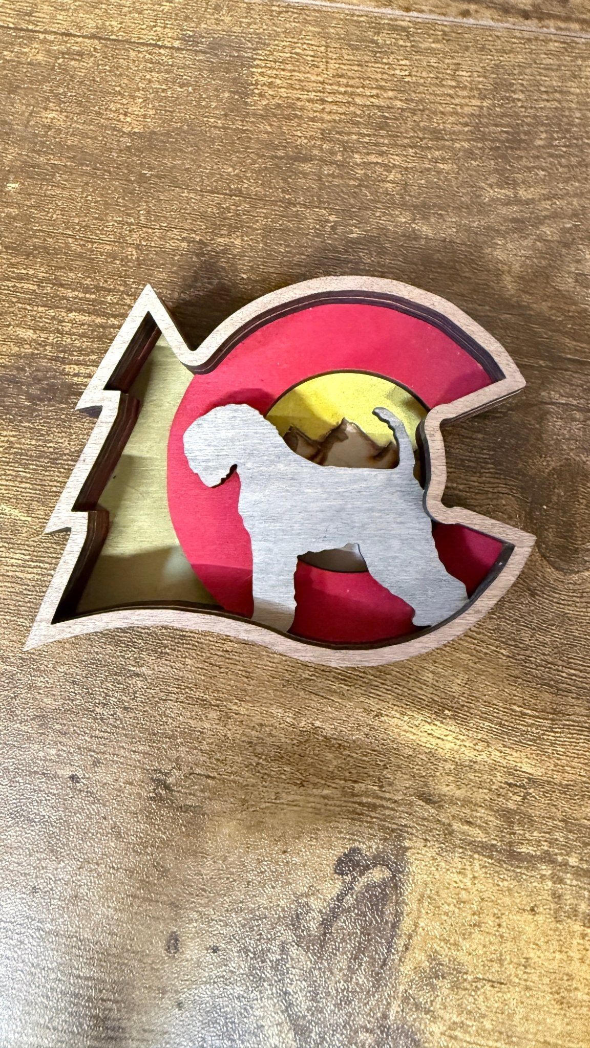 Colorado Dog Shelf Sitter by Bunkhouse Studio LLC, a decorative wooden dog figure perfect for shelf display.
