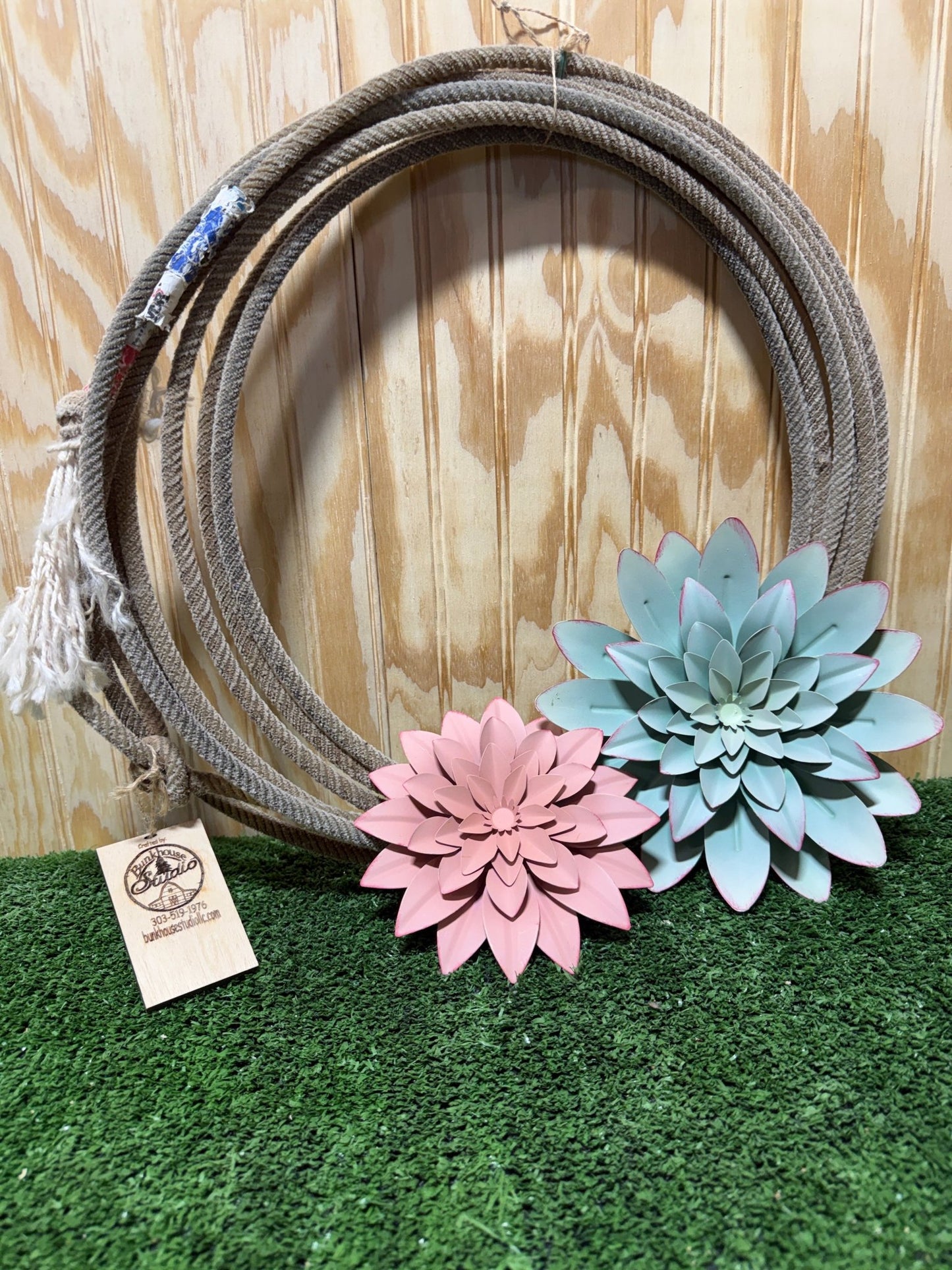 Flower rope wreath by Bunkhouse Studio LLC featuring vibrant flowers and natural rope, ideal for rustic or floral decor.