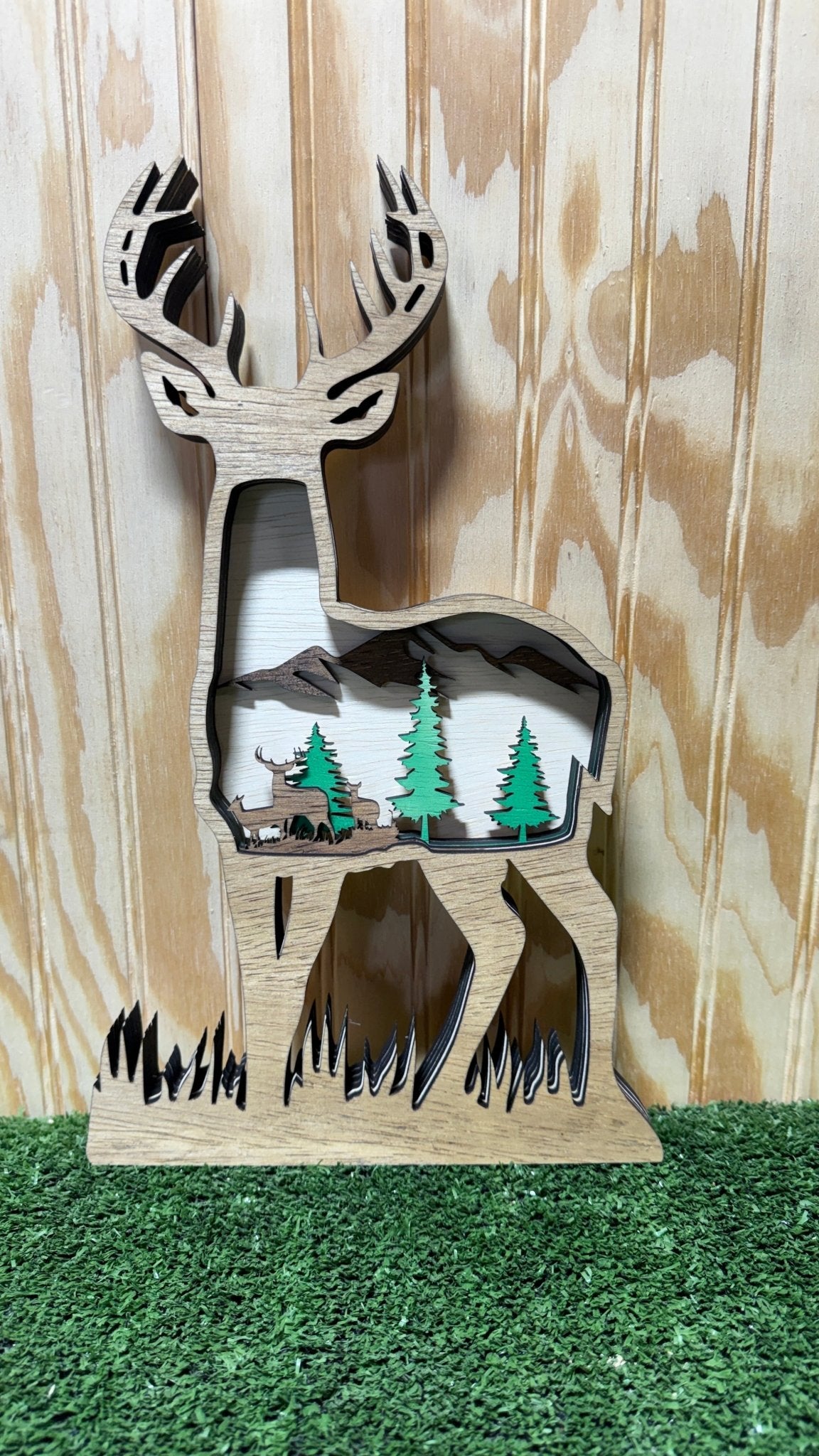 Layered wooden deer sculpture by Bunkhouse Studio LLC, detailed layered design, natural wood finish, decorative animal art piece.