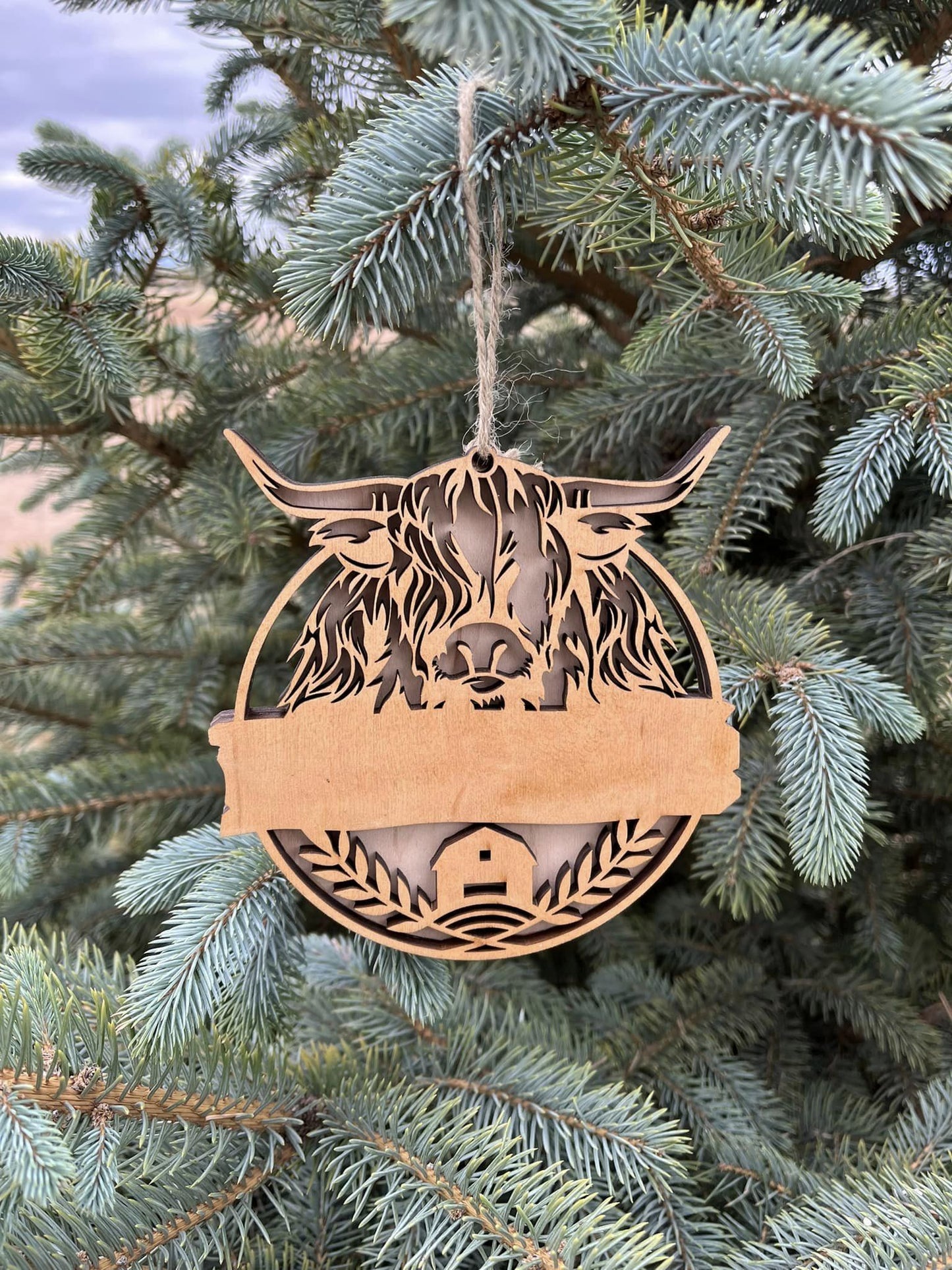 Highlander ornament by Bunkhouse Studio LLC with space for name and date, featuring detailed Highlander design and decorative accents.