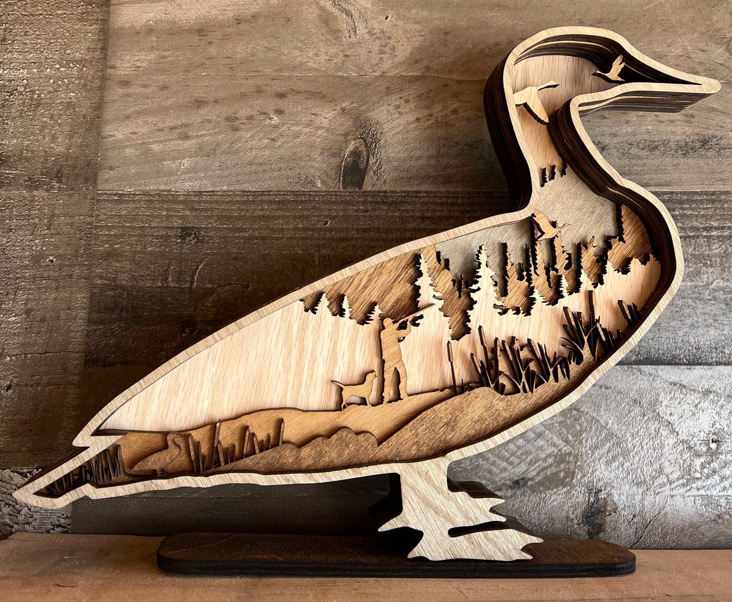 Handmade wood layer duck with one carved dog, hunting-themed decor piece for mancave or man gift by Bunkhouse Studio LLC.