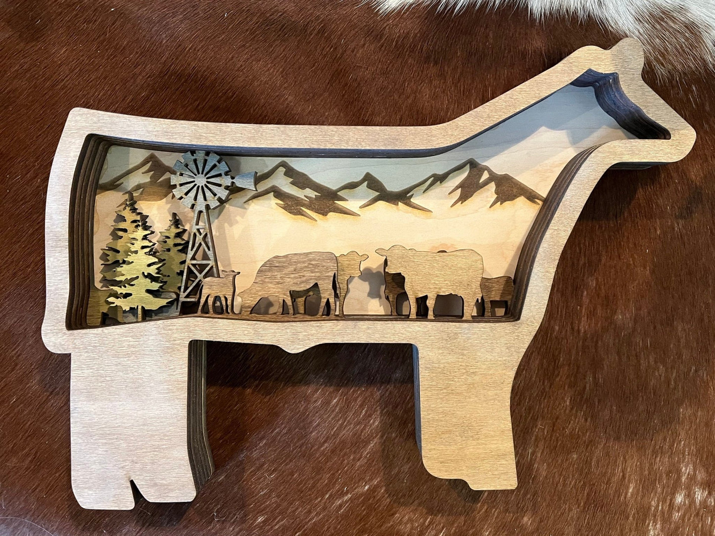 Handmade wall hanging featuring a steer with herd design, 23x30 inches, crafted by Bunkhouse Studio LLC for rustic home decor.