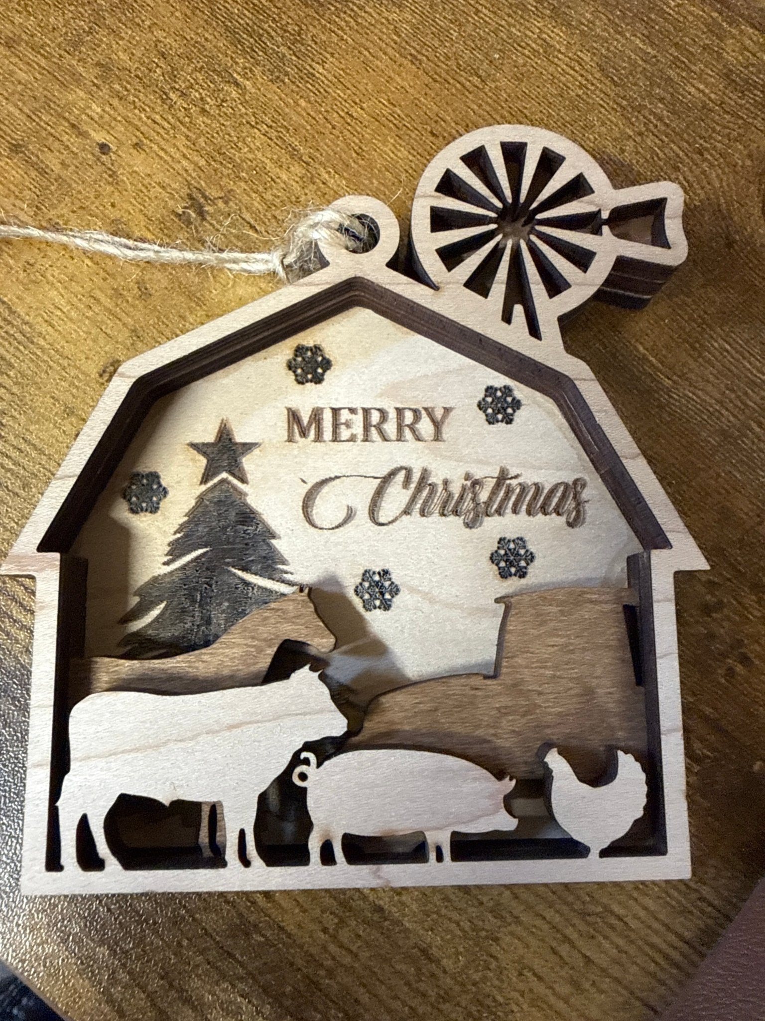 Rustic farm barn ornament by Bunkhouse Studio LLC, featuring detailed miniature wooden barn with weathered finish and festive charm.