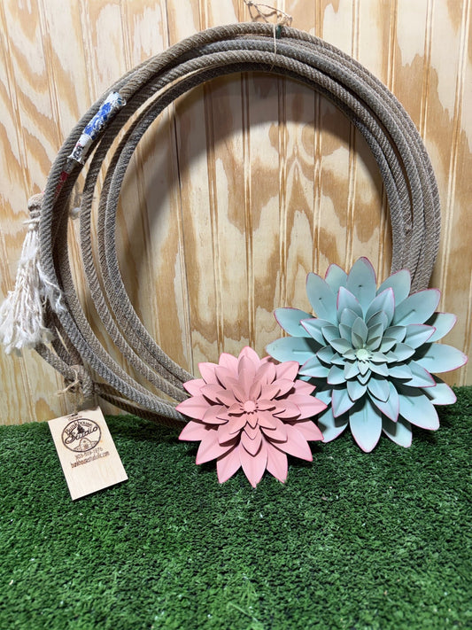 Flower rope wreath by Bunkhouse Studio LLC featuring vibrant flowers and natural rope, ideal for rustic or floral decor.