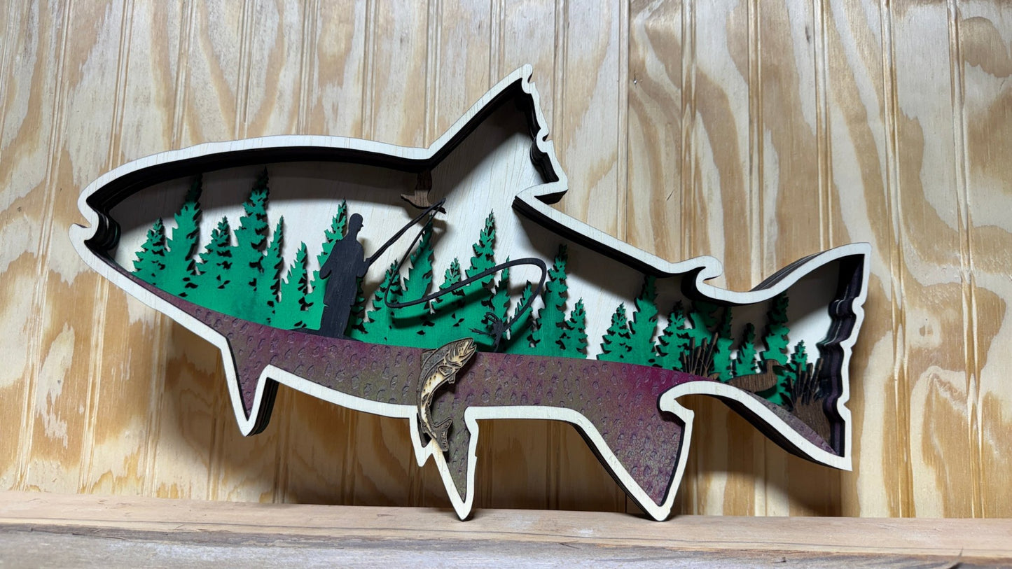 Handcrafted wooden trout wall art by Bunkhouse Studio, featuring a fly fisherman scene, ideal for rustic cabin or lodge décor.