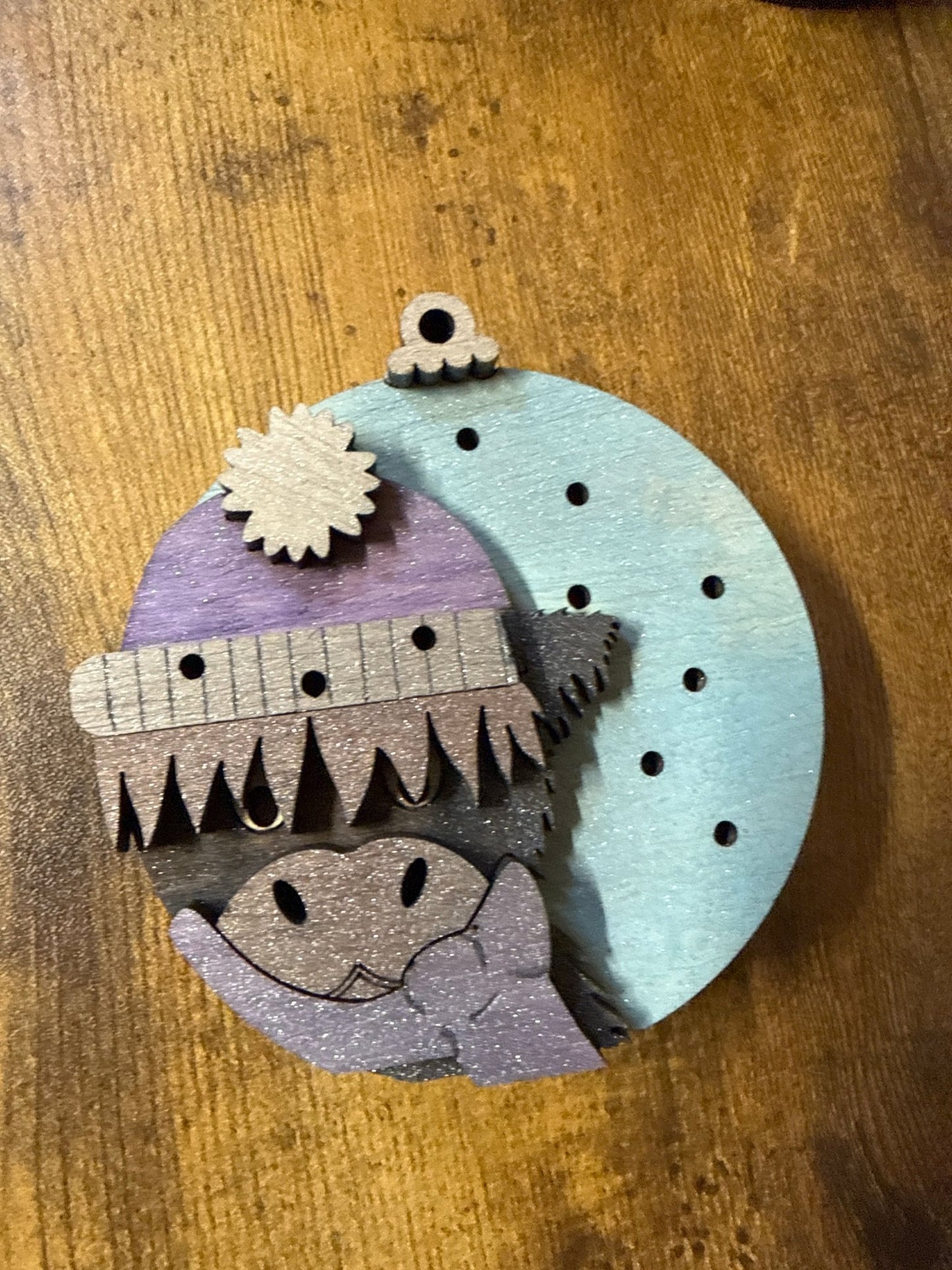 Light-up Highland Cow ornament by Bunkhouse Studio LLC, featuring a detailed plush Highland cow with a glowing LED light.