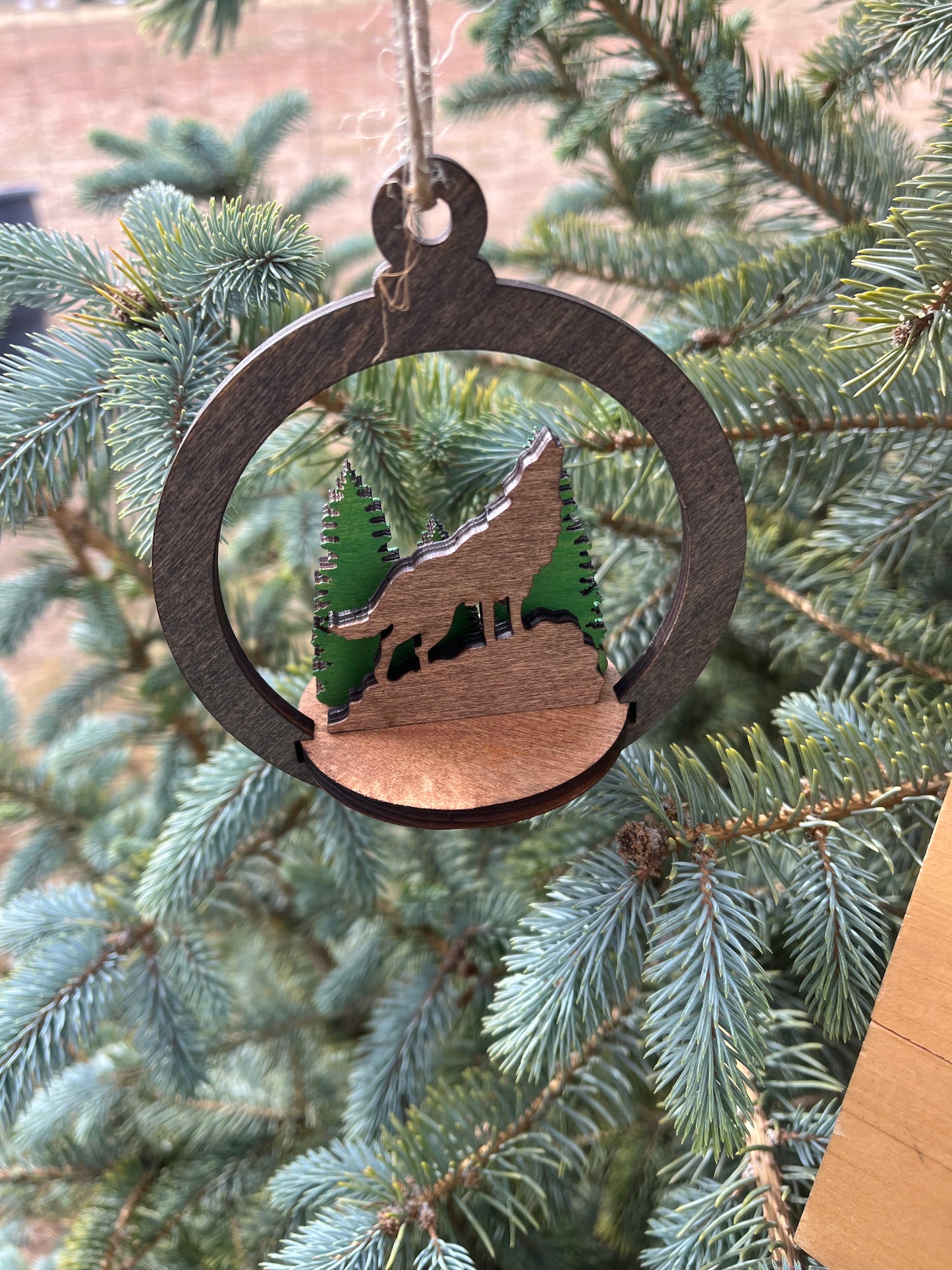 Two-layer round ornament by Bunkhouse Studio LLC with intricate circular design, perfect for holiday or decorative display.