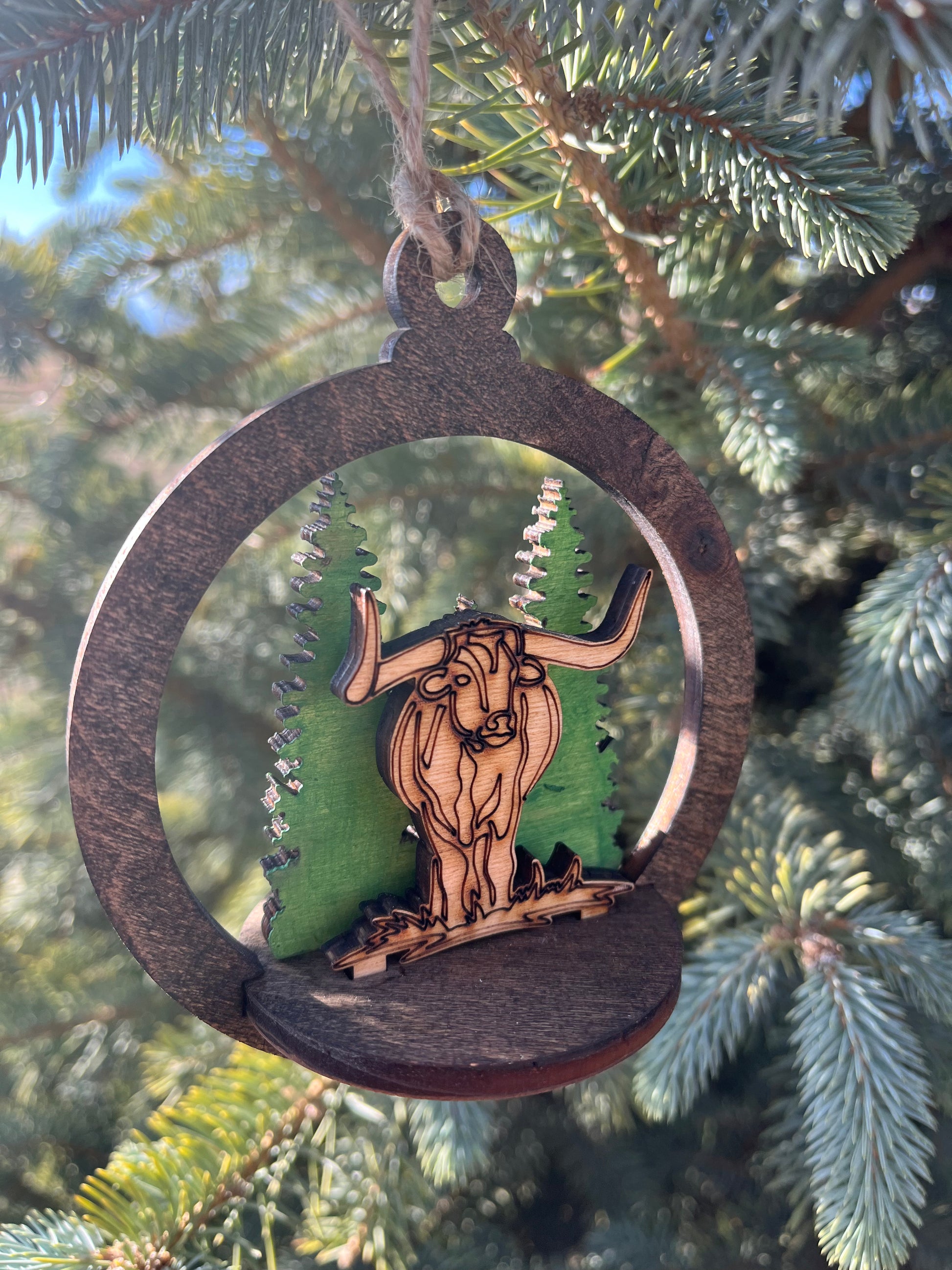 Two-layer circular ornament with intricate design by Bunkhouse Studio LLC, showcasing detailed craftsmanship and layered structure.
