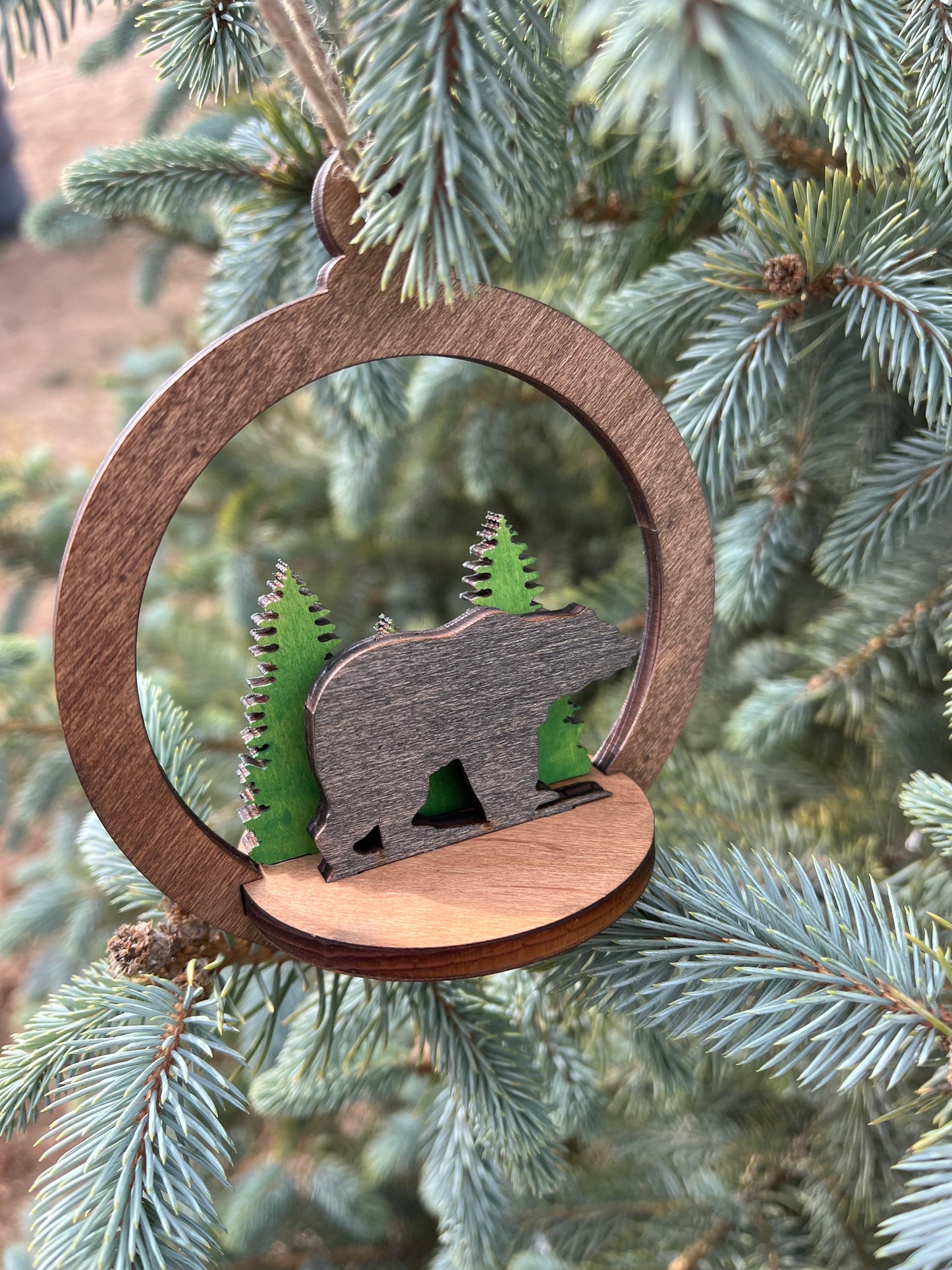Two-layer round ornament by Bunkhouse Studio LLC featuring a detailed circular design on a white background.