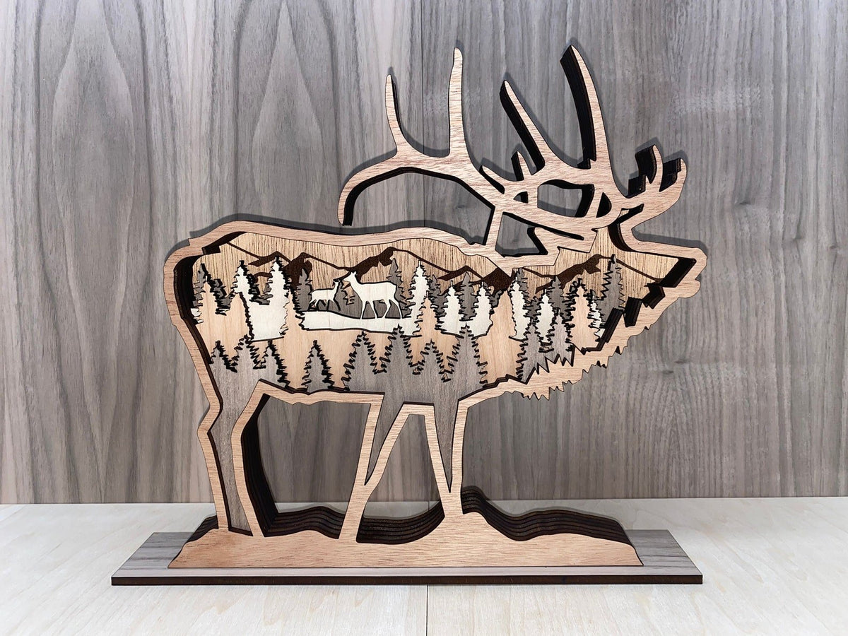 Layered elk sculpture by Bunkhouse Studio LLC, featuring detailed, multi-layered wooden elk animal art on a white background.